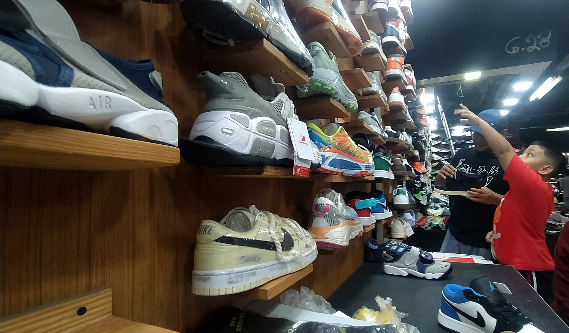Pembeli saat melihat deretan sepatu  di Pasar Taman Puring, Mayestik, Kebayoran Baru, Jakarta, Sabtu (30/3/2024). (Indonesiaglobe/Oke Atmaja)