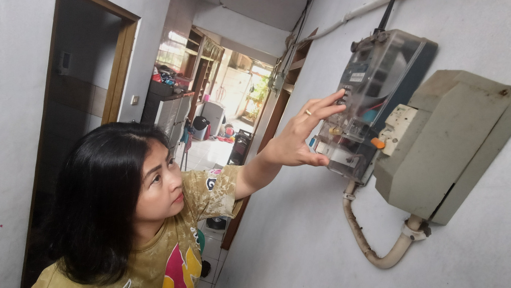 Warga memeriksa meteran listrik di rumahnya, Jakarta, Kamis (5/6/2025).  (Beritanasional.com/ Oke Atmaja)