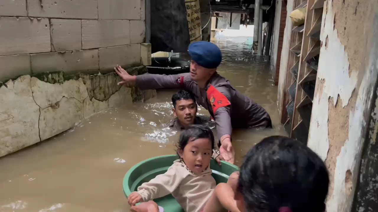 Anggota Brimob Polda Metro Jaya membantu korban banjir di Kebon Pala, Jakarta Timur. (Foto/Istimewa)