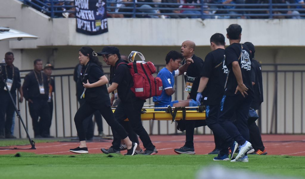 Pemain Persib Bandung Achmad Jufriyanto ditandu ke luar lapangan setelah mengalami cedera patah tulang rusuk. (Foto/persib.co.id)