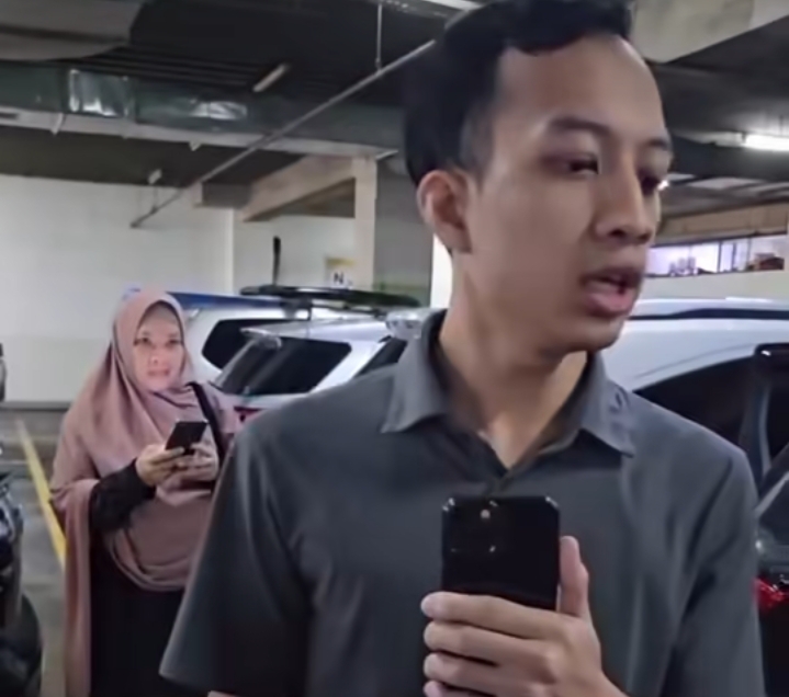 Pria yang mengaku anak Propam memakai barbuk mobil sitaan. (Foto/Istimewa)