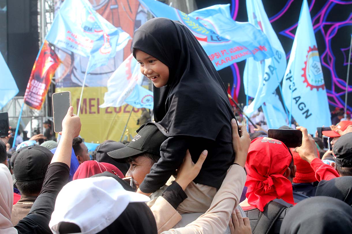Buruh membawa anaknya saat peringati hari buruh di Lapangan Monas, Jakarta Pusat, Kamis (1/5/2025).(Beritanasional.com/Oke Atmaja)