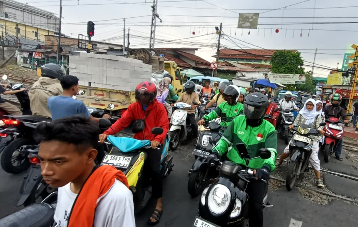 Pengendara sepeda motor melintas di perlintasan sebidang kereta api di Stasiun Pondok Jati, Jakarta,Kamis(30/4/2026). (Beritanasional.com/Oke Atmaja)