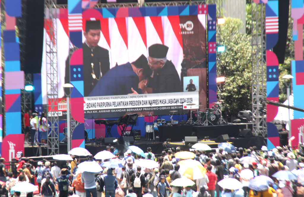 Warga menunggu kedatangan Presiden dan Wakil Presiden Prabowo Subianto-Gibran Rakabuming Raka di Bundaran HI  Jakarta, Minggu (20/10/2024).  (Beritanasional.com/Oke Atmaja)