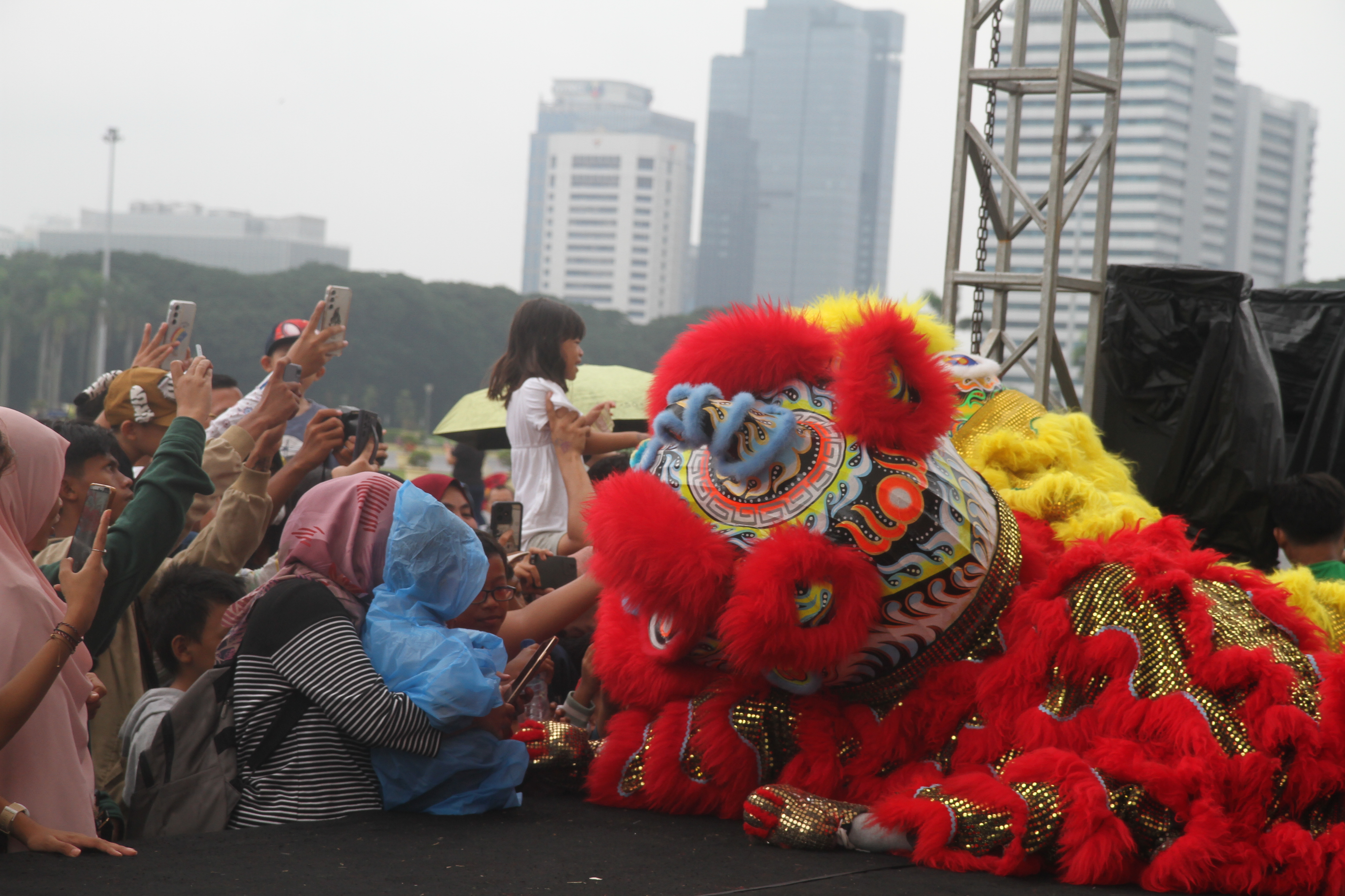 Masyarakat menyaksikan pertunjukan barongsai di Monumen Nasional (Monas), Jakarta, Selasa (28/1/2025). (BeritaNasional/Oke Atmaja)