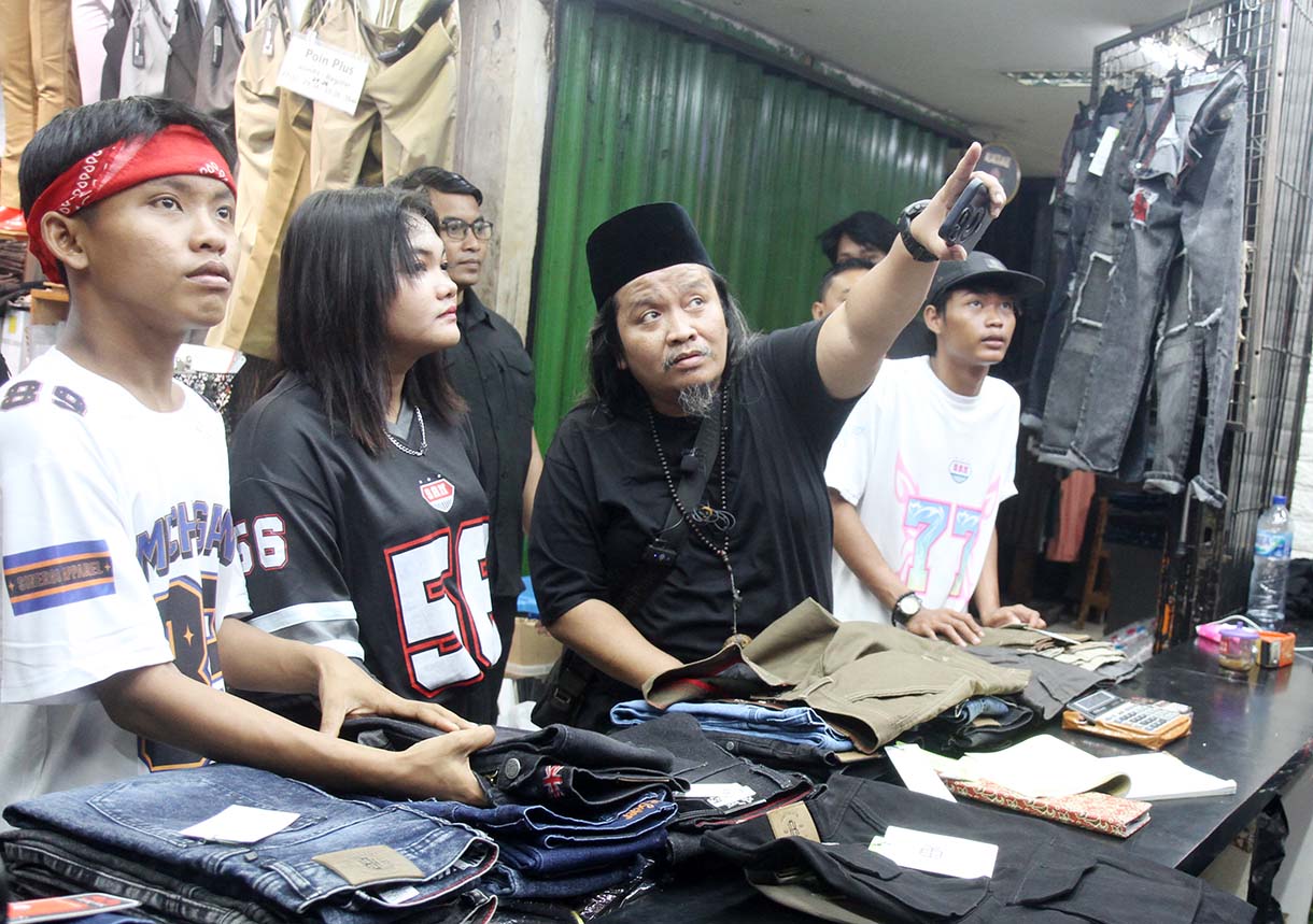 Personel Geng Citayam Fashion Week Bonge, Kurma dan Roy bersama CEO Sinergi ADV Nusantara H.Prama Tirta (kedua kiri) berbelanja produk lokal topi di Pasar Blok A Tanah Abang, Jakarta, Senin (12/5/2025).(Beritanasional.com/Oke Atmaja)