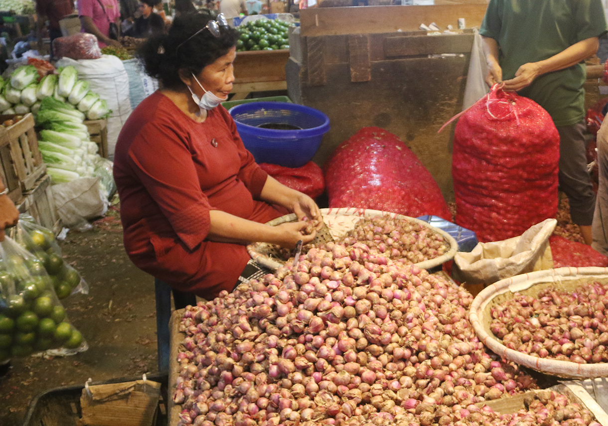 Pedagang sedang menilah bawang putih di Pasar Induk, Kramat Jati, Jakarta, Sabtu (11/4/2026).(Beritanasional.com/Oke Atmaja)