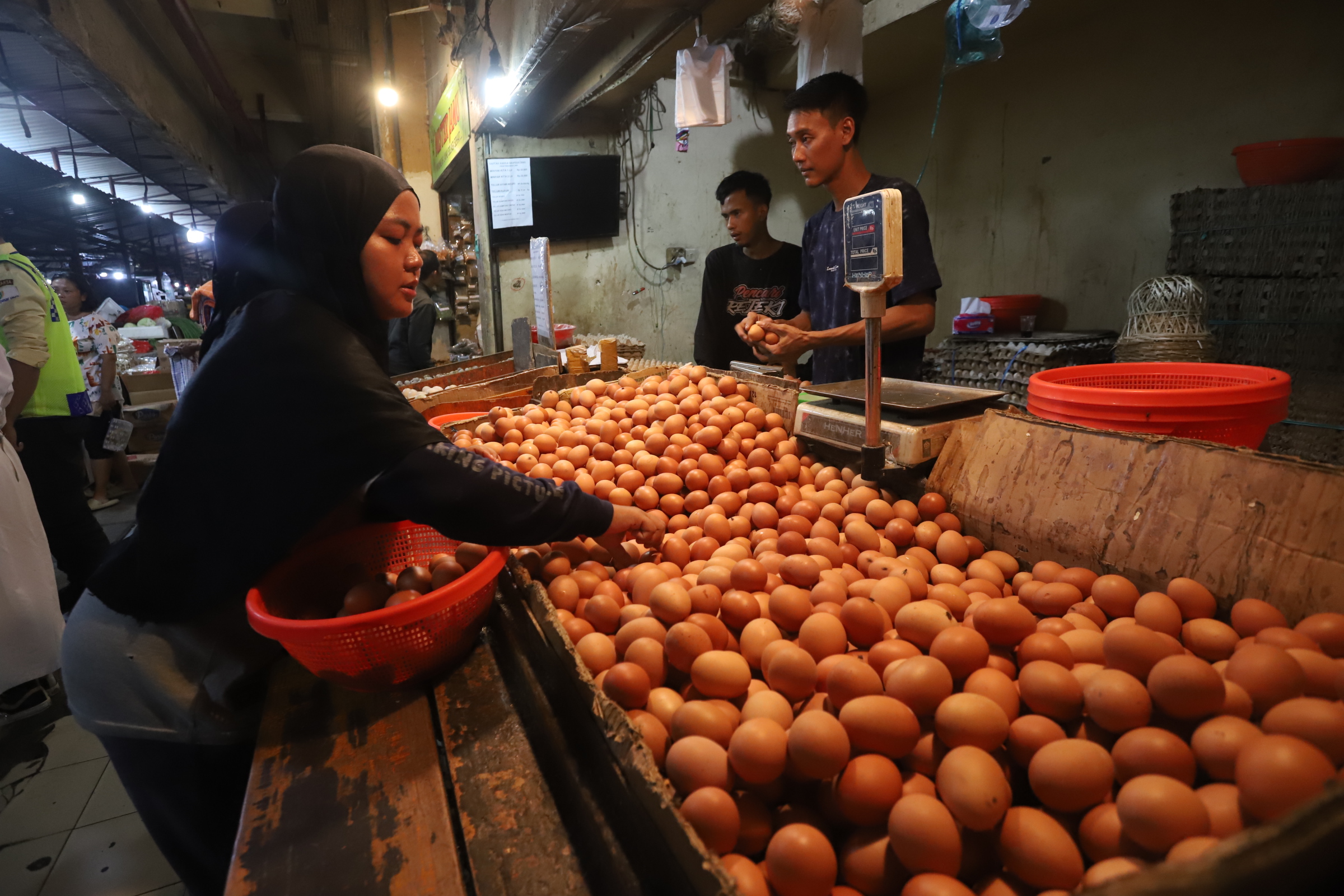 Pedagang saat merapihkan telur ayam di toko miliknya di Pasar Kebayoran Lama, Jakarta,Minggu (5/5/2024).  (BeritaNasional.Com/Oke Atmaja)