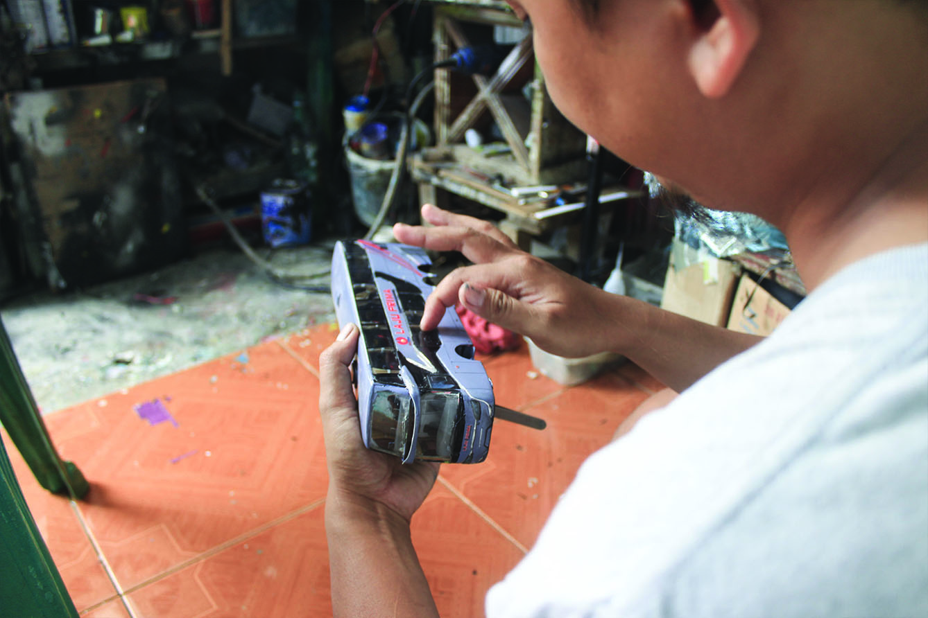 Perajin menyelesaikan miniatur Bus AKAP di Workshop belang bentong, Depok, Jawa Barat, Sabtu (13/7/2024). (BeritaNasional.com/Oke Atmaja)