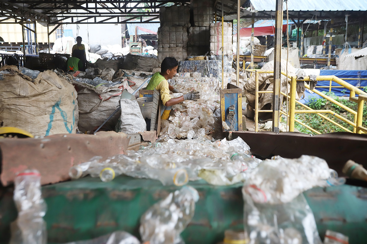 Sejumlah pekerja memilah sampah botol dan galon plastik untuk didaur ulang di Koperasi Pemulung Berdaya,Tangerang Selatan, Banten, Minggu (21/7/2024). (BeritaNasional.com/Oke Atmaja)