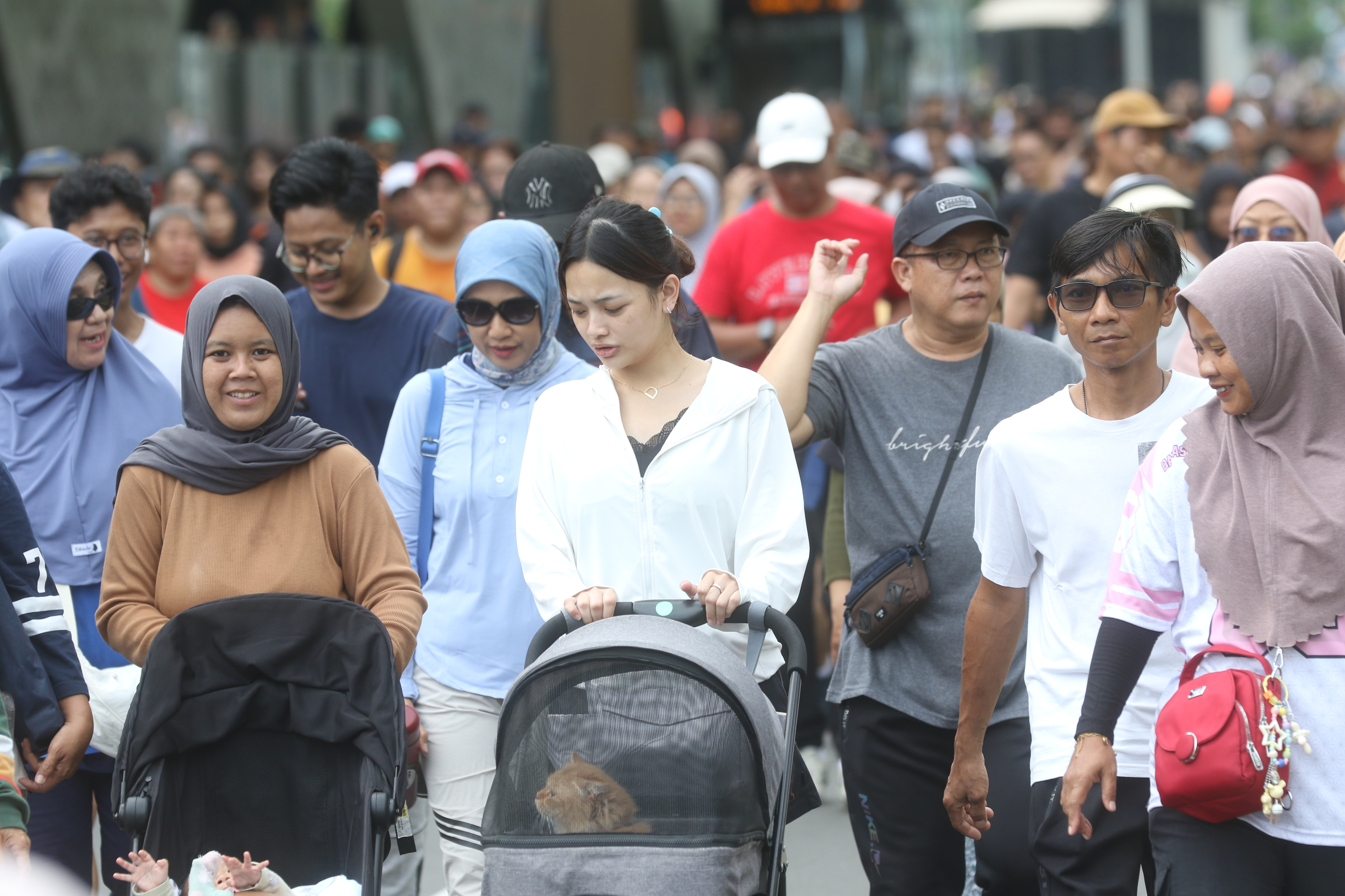 Warga berolahraga saat Hari Bebas Kendaraan Bermotor (HBKB) di Kawasan Bundaran HI, Jakarta, Minggu (23/11/2025). (Beritanasional.com/Oke Atmaja)