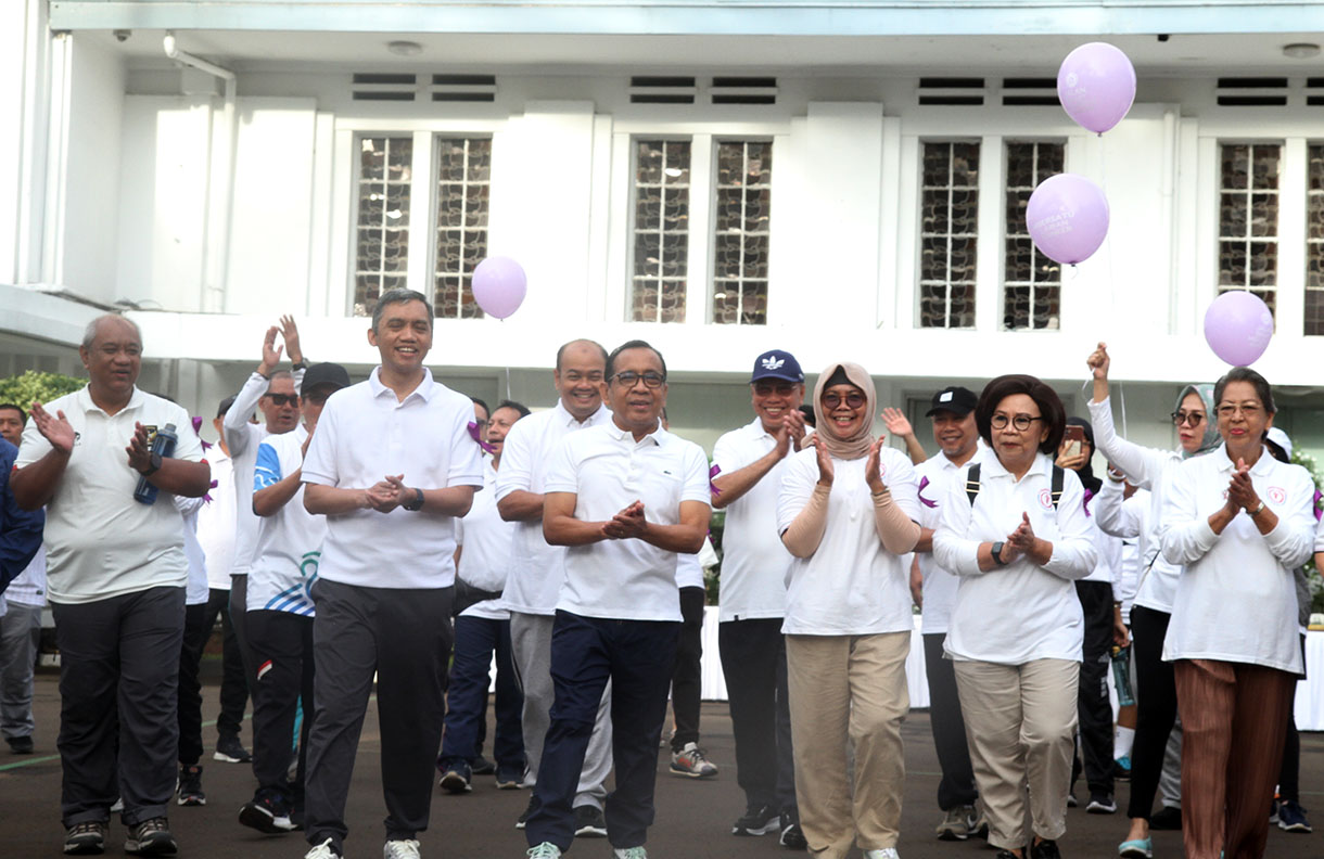 Menteri Koordinator Bidang Pembangunan Manusia dan Kebudayaan (Menko PMK) Pratikno (kedua kiri depan) bersama pengurus penyintas kanker Yayasan Kanker Indonesia Rini Hoepoedio (kedua kanan) dan sejumlah penyintas kanker mengikuti jalan sehat melawan kanker di halaman Monas, Jakarta, Rabu (5/2/2025).  (Beritanasional.com/Oke Atmaja)