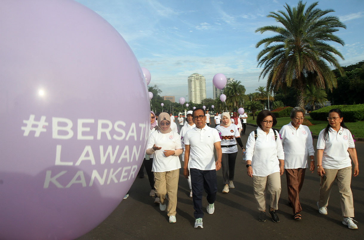 Menteri Koordinator Bidang Pembangunan Manusia dan Kebudayaan (Menko PMK) Pratikno (kedua kiri depan) bersama pengurus penyintas kanker Yayasan Kanker Indonesia Rini Hoepoedio (kedua kanan) dan sejumlah penyintas kanker mengikuti jalan sehat melawan kanker di halaman Monas, Jakarta, Rabu (5/2/2025).  (Beritanasional.com/Oke Atmaja)