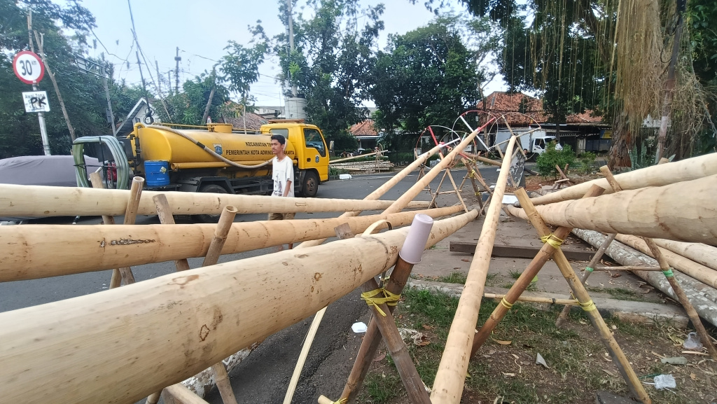 Jelang HUT RI, Penjual Pohon Pinang Mulai Bermunculan Pekerja mengupas kulit batang pohon pinang di kawasan Manggarai, Jakarta, Kamis (7/8/2025). (Beritanasional.com/Oke Atmaja)