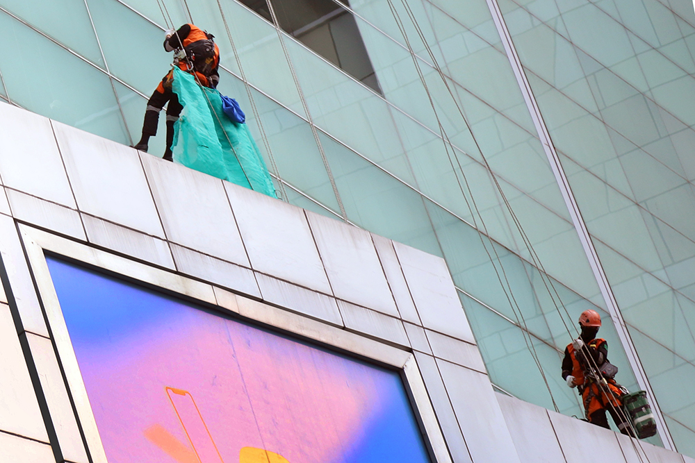 Kemnaker Perluas Cakupan Perlindungan Kerja Pekerja membersihkan kaca dinding west mall Kempinski, Jakarta. (BeritaNasional/Elvis Sendouw)
