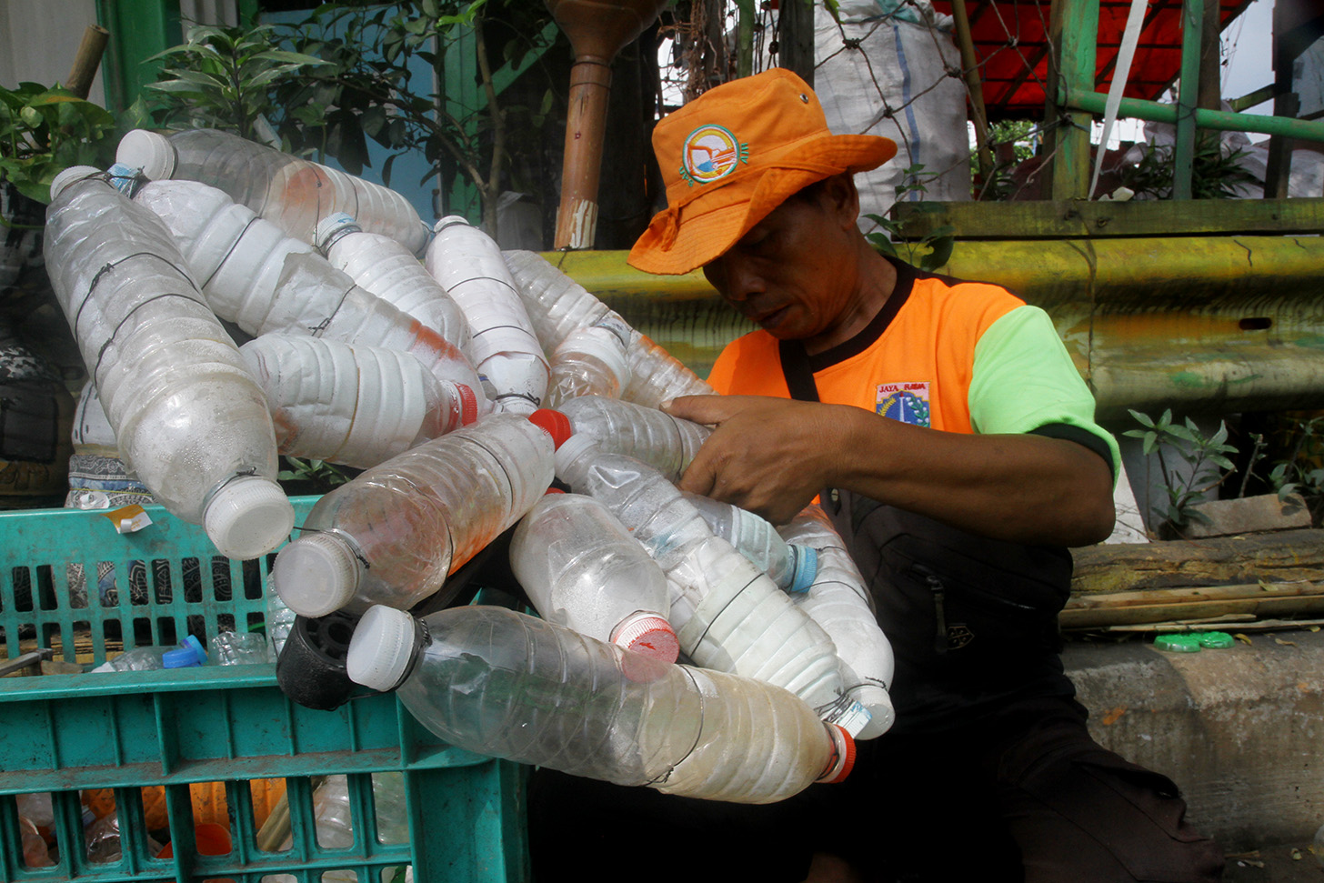 Petugas Unit Penanganan Sampah Badan Air (UPS BA) menyelesaikan pembuatan perahu dari limbah botol plastik di Kwitang, Jakarta, Sabtu (15/7/2024).(BeritaNasional.Com/Oke Atmaja)