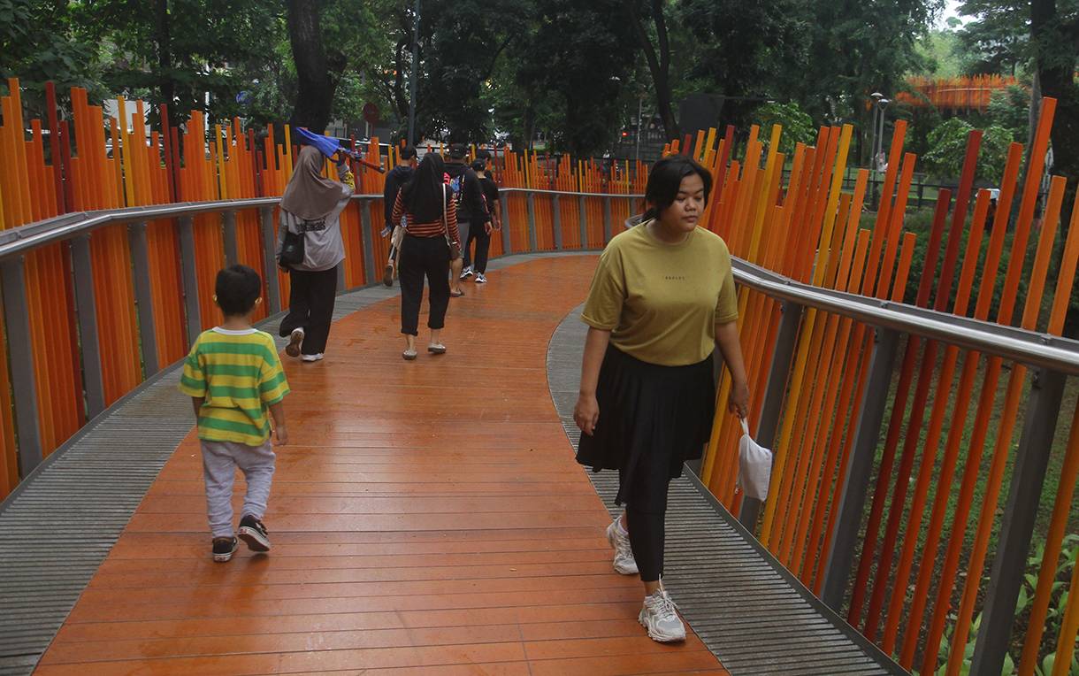 Warga melintasi berkunjung di Taman Tebet Eco Park, Jakarta, Kamis (1/1/2026).  (Beritanasional.com/Oke Atmaja)