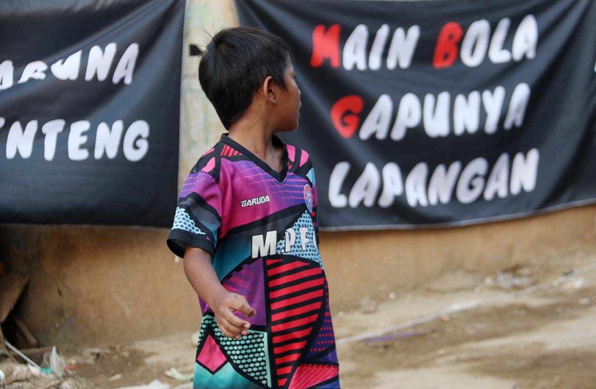 Anak-anak mengikuti pertandingan Turnamen Sepak Bola "Liga Aspal" U-13 di lapangan sederhana kawasan permukiman padat pinggir rel RT 09/RW 08, Menteng Jaya, Jakarta, Sabtu (20/6/2026). (Beritanasional.com/Oke Atmaja)