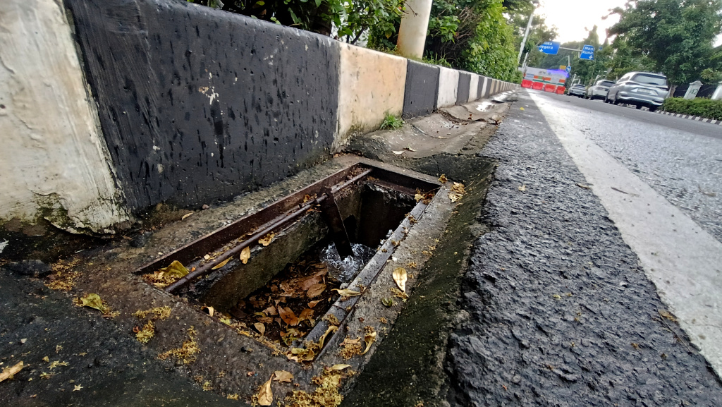 Lubang Drainase tanpa Penutup Besi di Jakarta Kendaraan melintas di samping lubang drainase yang besi penutupnya hilang di Jalan Proklamasi, Jakarta, Minggu (11/5/2025). (Berita nasional.com/ Oke Atmaja)