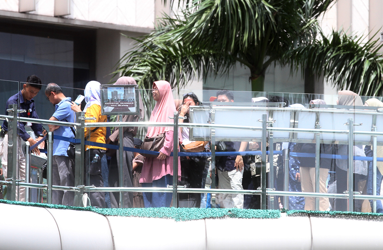 Pengunjung berwisata di anjungan Halte Bundaran Hotel Indonesia, Jakarta, Senin (27/1/2025).(BeritaNasional/Oke Atmaja)