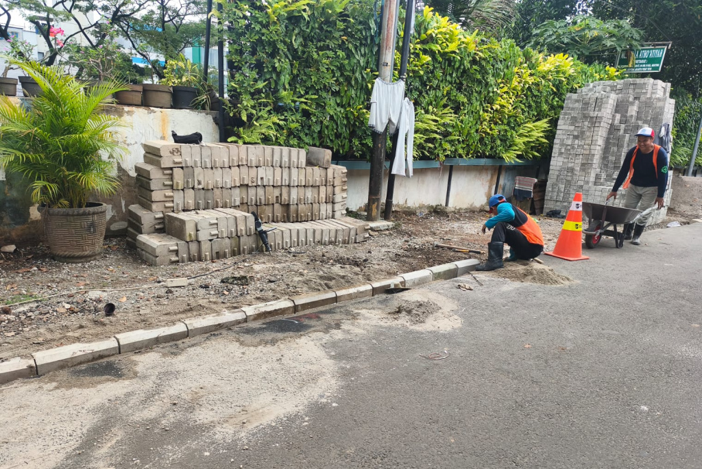 Pekerja menyelesaikan proyek revitalisasi trotoar di Menteng Tenggulun, Jakarta, Jumat (10/4/2026). (Beritanasional.com/Oke Atmaja)