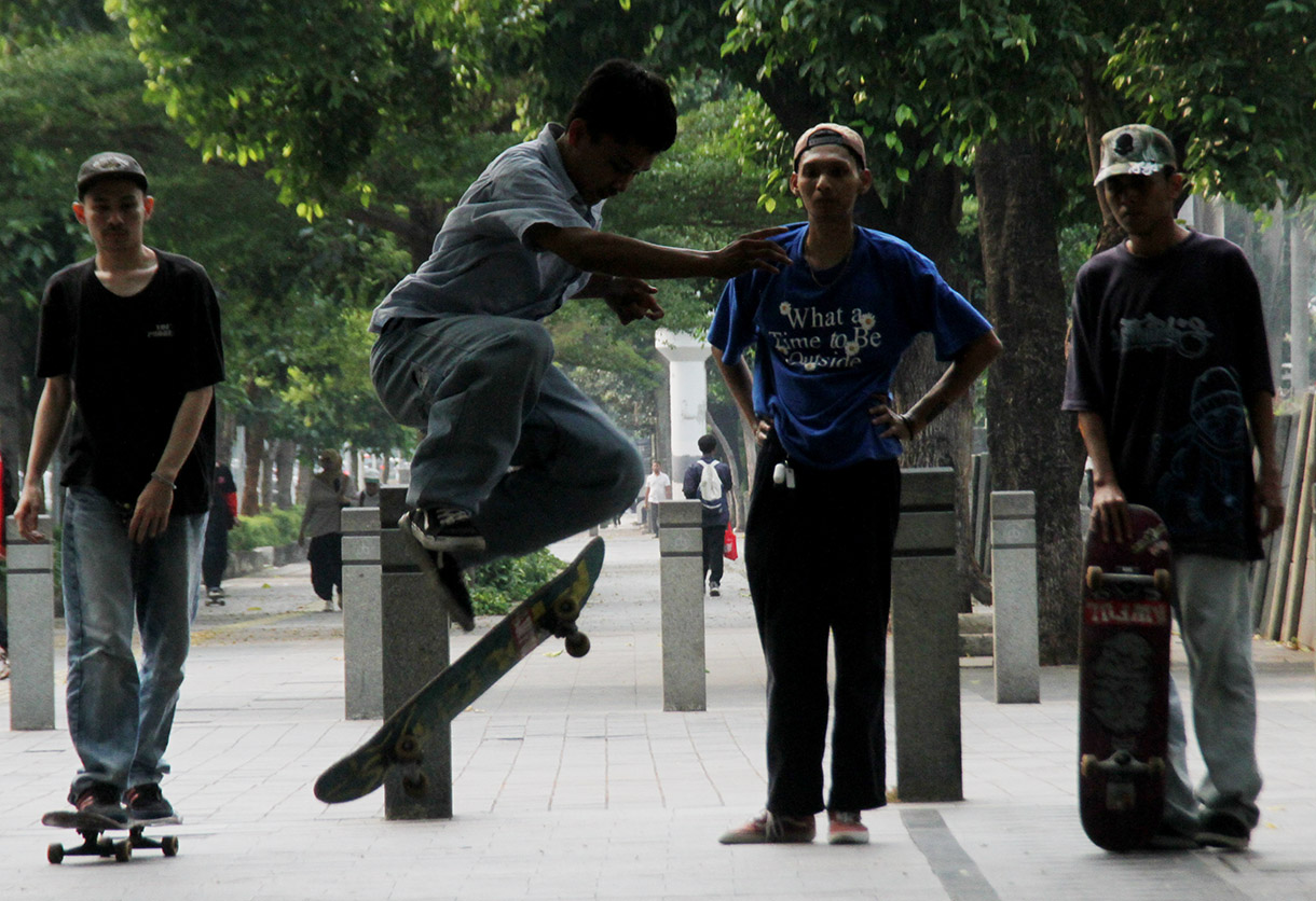 Seorang pemuda bermain skateboard di kawasan Sudirman, Jakarta, Minggu (28/7/2024).  (BeritaNasional.com/Oke Atmaja)