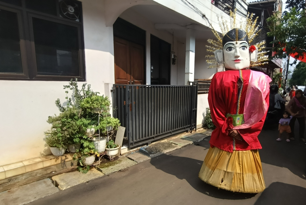 Ondel-ondel Dilarang Ngamen di Jakarta Pengamen ondel-ondel mengamen di perkampungan kawasan Menteng, Jakarta, Rabu (11/6/2025). (Beritanasional.com/Oke Atmaja)