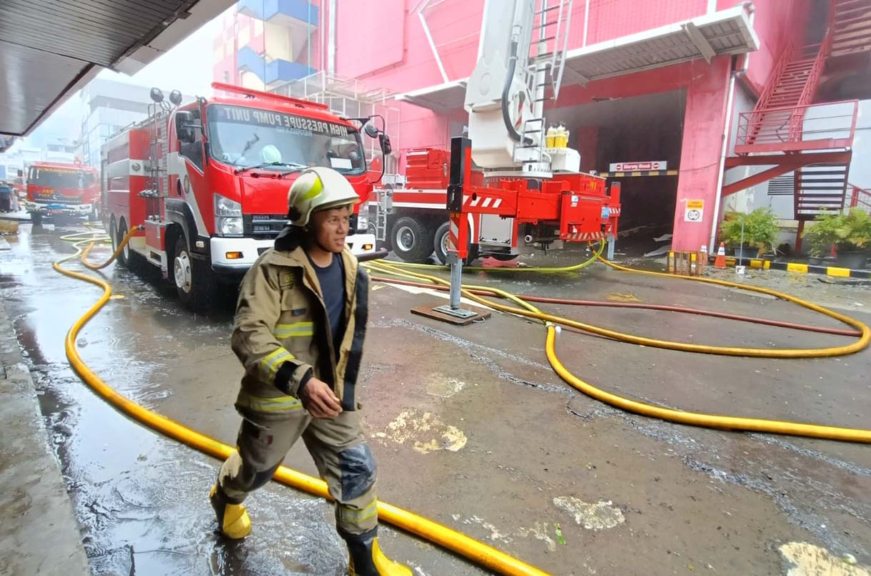 Petugas pemadam kebakaran terus melakukan penyemprotan untuk pendinginan setelah terjadi kebakaran di Glodok Plaza, Jakarta, Kamis (16/1/2025). (BeritaNasional.com/Oke Atmaja)