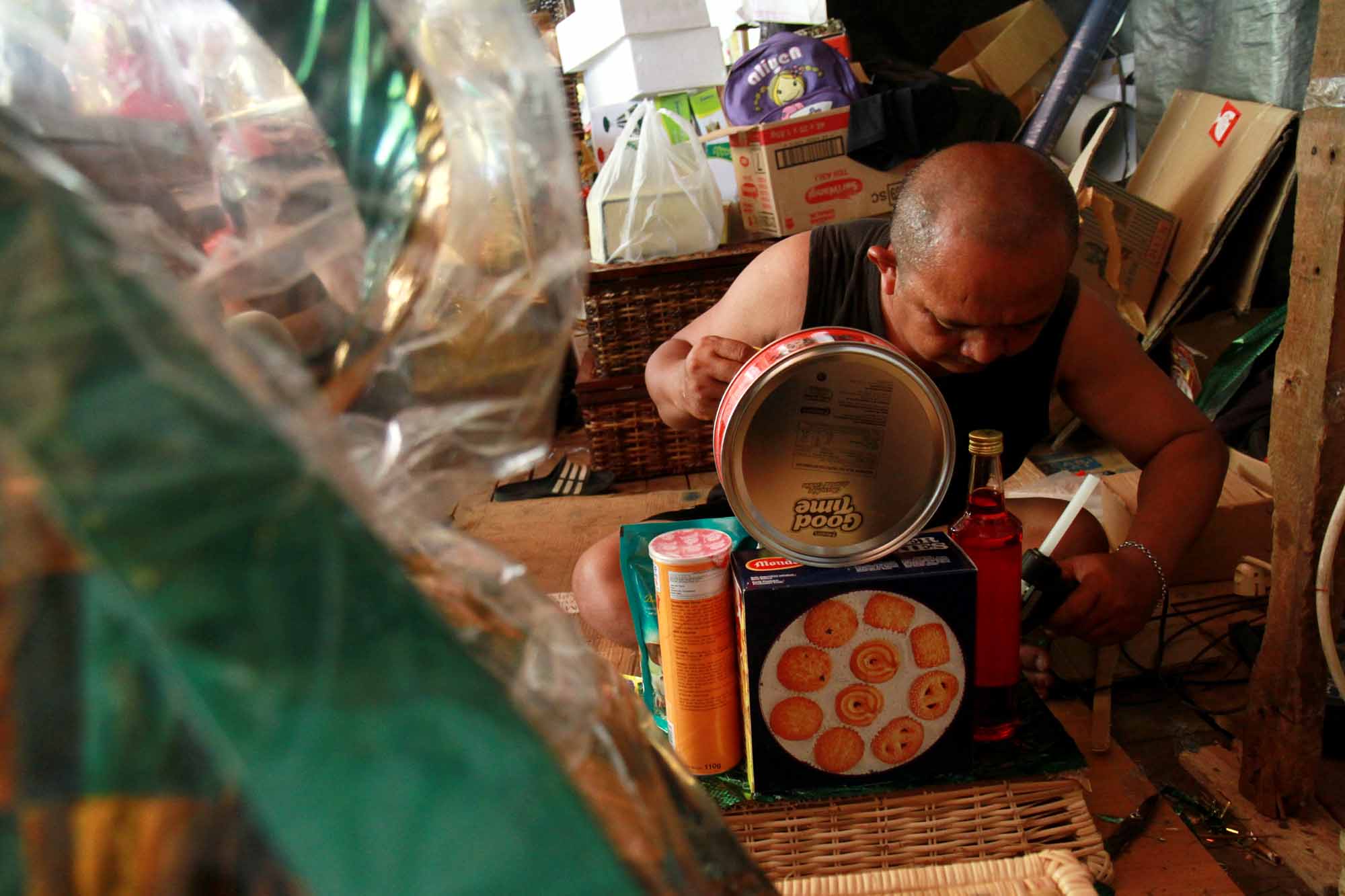 Pedagang menyelesaikan pembuatan parsel Lebaran berisi produk makanan ringan di Pasar Kembang, Cikini, Jakarta, Rabu (22/3/2024). (IndonesiaGlobe/Oke Atmaja)