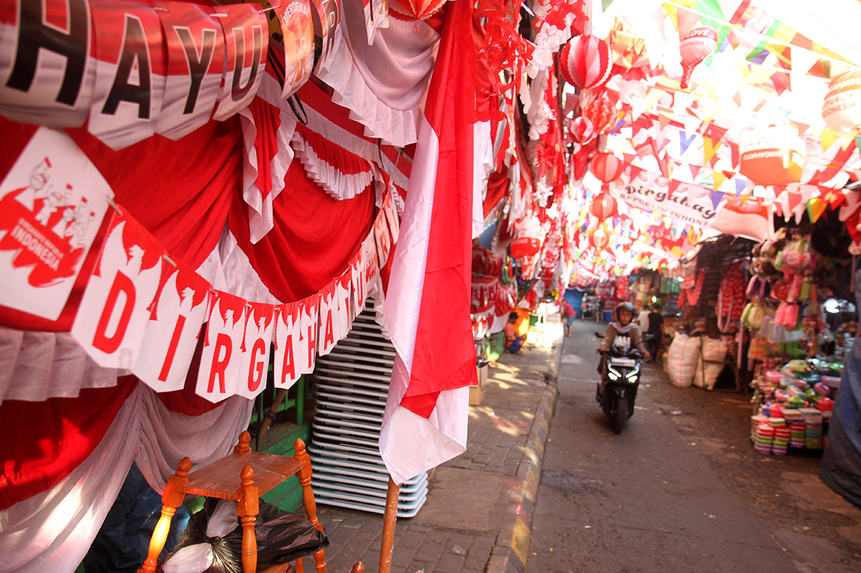 Warga melihat pernak-pernik Merah Putih  di Pasar Jatinegara, Jakarta Timur, Selasa (6/8/2024). (BeritaNasional.com/Oke Atmaja)