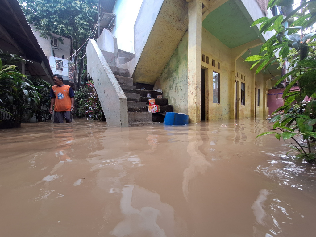 Pejaten Timur Terendam Banjir Warga beraktivitas saat banjir setinggi 60 Cm di Rt 16 Rw 06, Kawasan Bantaran Kali Ciliwung, Pejaten Timur, Pasar Minggu, Jakarta Selatan, Selasa (8/7/2025). (Beritanasional.com/Oke Atmaja)