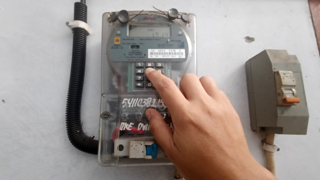 Pemerintah Memberlakukan Diskon Tarif Listrik 50 Persen Warga memeriksa meteran listrik di rumahnya, Jakarta, Kamis (5/6/2025). (Beritanasional.com/ Oke Atmaja)