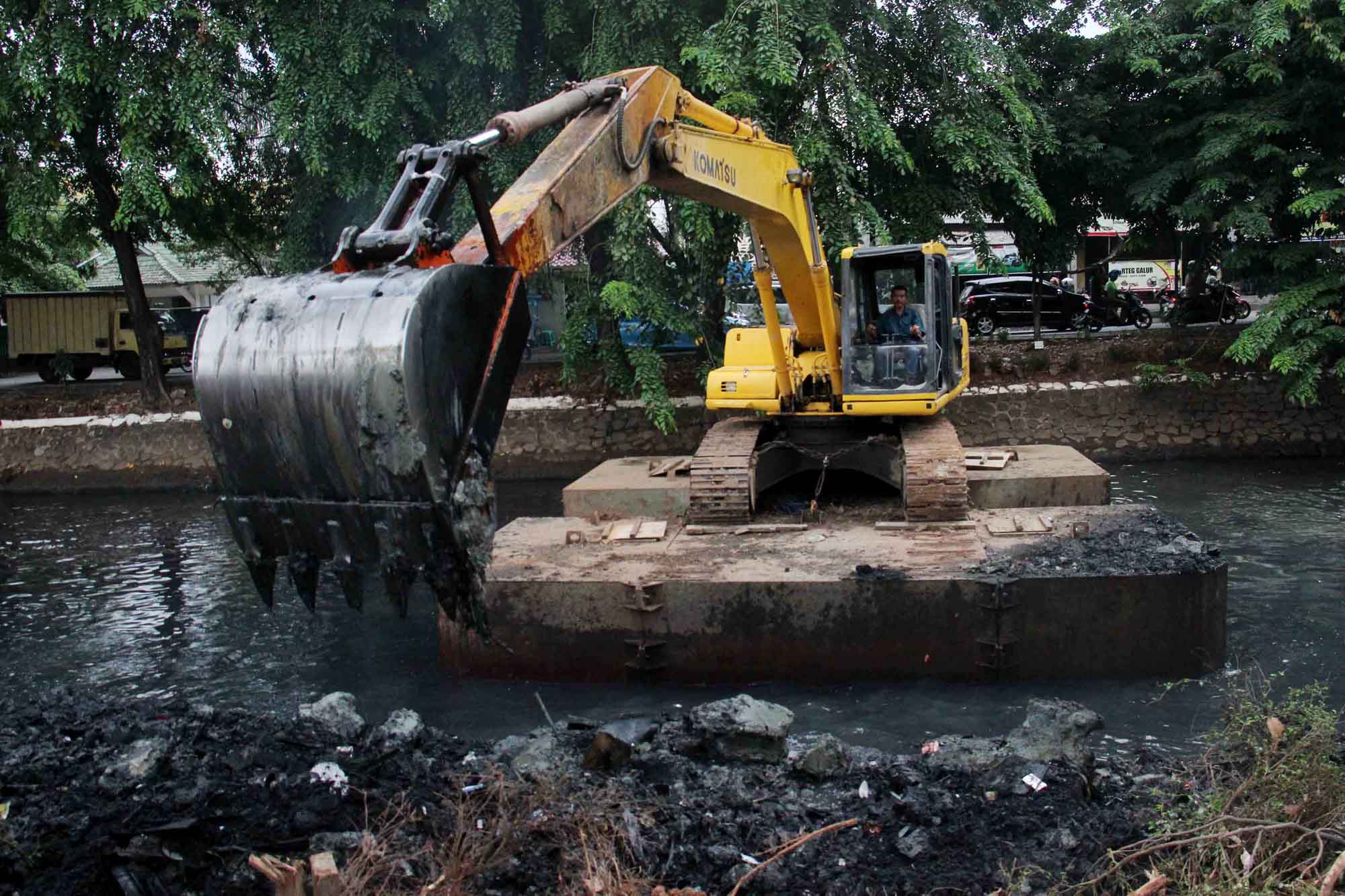 Alat berat ekskavator saat mengeruk lumpur di kali Sunter, Jakarta, Senin (4/11/2024).  (BeritaNasional.com/Oke Atmaja)