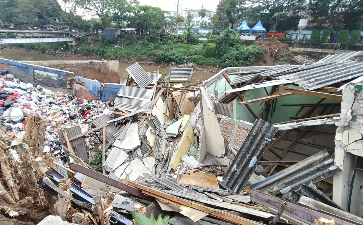 Petugas  Sumber Daya Air( SDA)  Jakarta Pusat  membereskan rerutuhan akibat tanah lonsor di area, Dipo Sampah Pasar Pintu Air, Jalan Petamburan, Tanah Abang, Jakarta, Sabtu (27/6/2026).   (Beritanasional.com/Oke Atmaja)