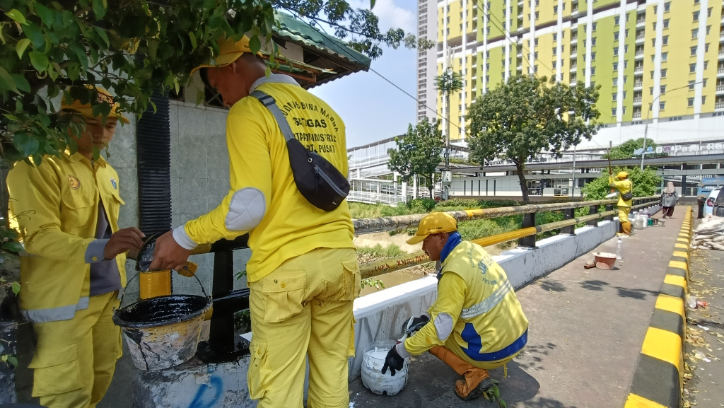 Pengecatan Jembatan Kali Ciliwung Sejumlah petugas Sudin Bina Marga Jakarta Pusat mengecat jembatan Kali Ciliwung di Jalan Menteng Jaya, Jakarta,Senin (5/5/2025). (Beritanasional.com/Oke Atmaja)