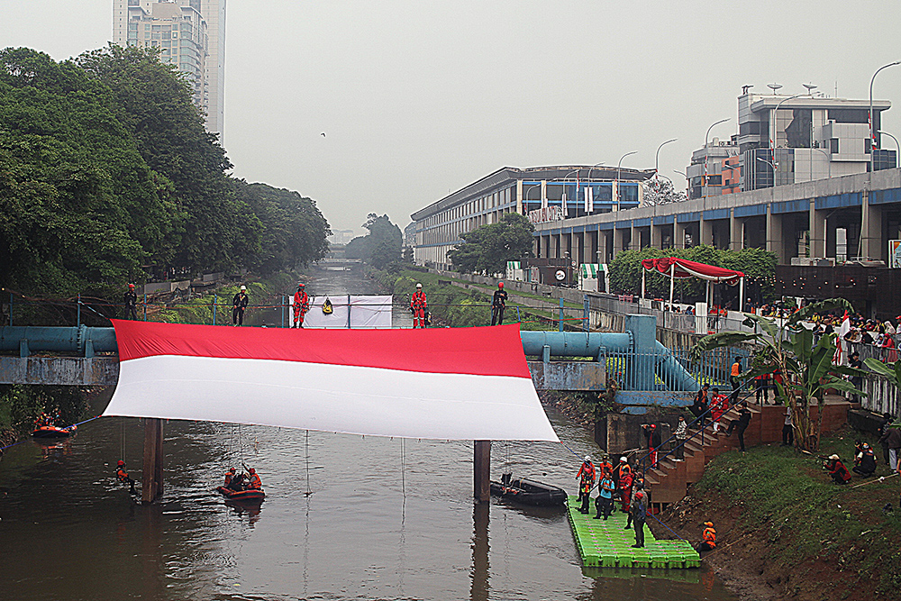 Pengibaran Bendera Merah Putih Raksasa di Sungai Ciliwung Petugas gabungan mengibarkan Bendera Merah Putih berukuran raksasa di sungai Ciliwung. (BeritaNasional/Elvis Sendouw)
