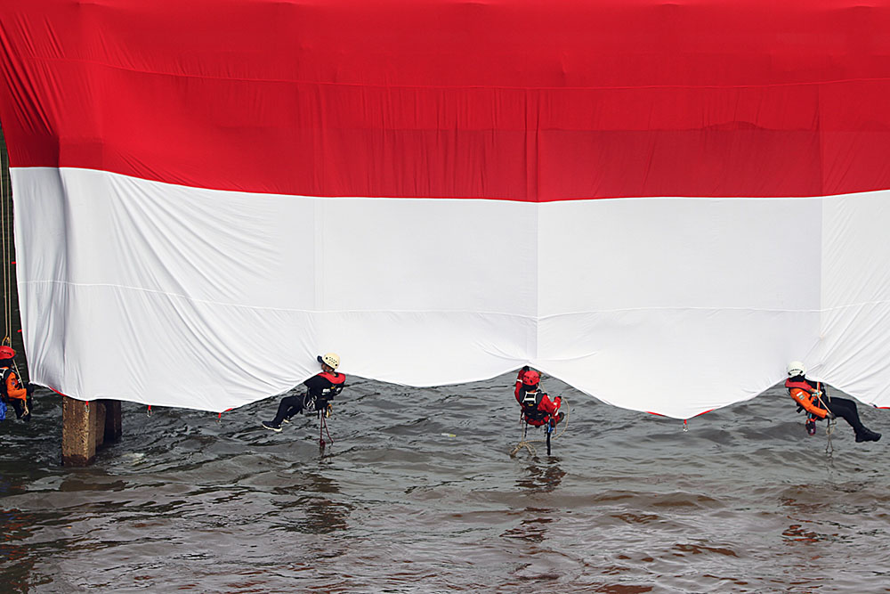 Pengibaran Bendera Merah Putih Raksasa di Sungai Ciliwung Petugas gabungan mengibarkan Bendera Merah Putih berukuran raksasa di sungai Ciliwung. (BeritaNasional/Elvis Sendouw)