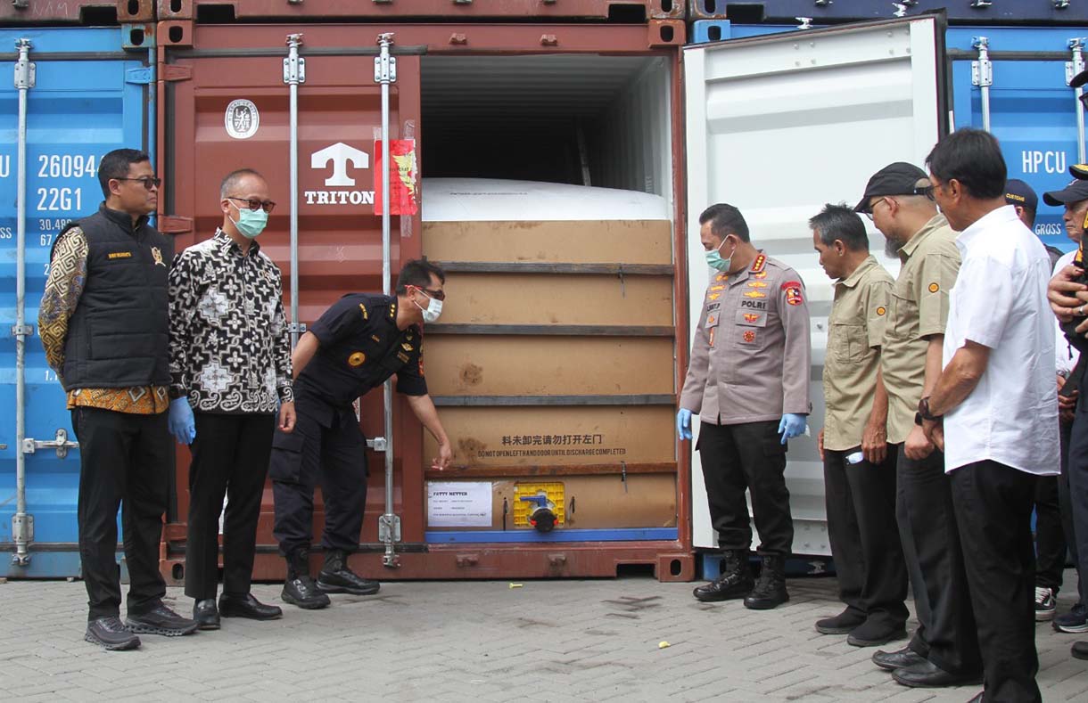 Petugas Bea Cukai menutup pintu kontainer berisi produk turunan minyak sawit mentah atau crude palm oil (CPO) pada konferensi pers penindakan produk yang melanggar aturan ekspor di Jakarta Utara, Kamis (6/11/2025).  (Beritanasional.com/Oke Atmaja)
