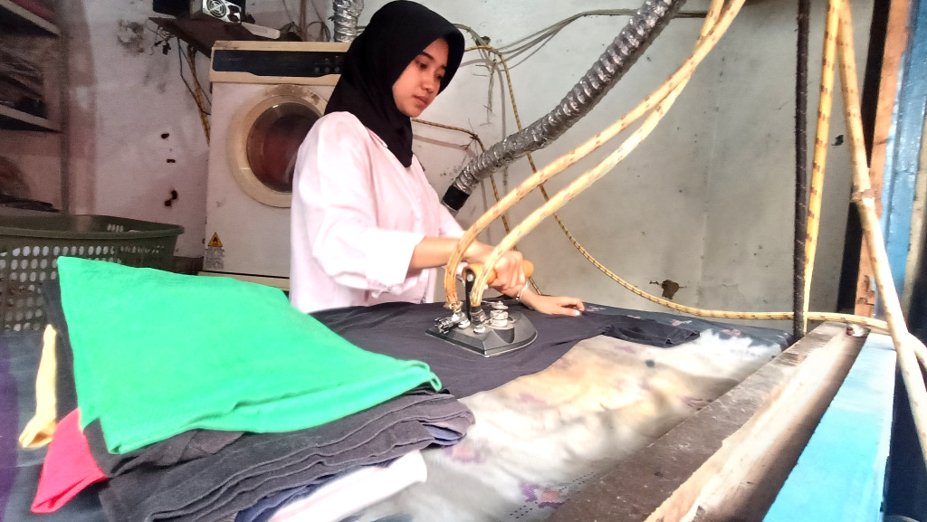 Realisasi Penyaluran KUR 2025 Pekerja meneriska pakaian di salah satu usaha cuci pakaian di Menteng Jaya, Jakarta, Senin (01/09/2025). (Beritanasional.com/Oke Atmaja)