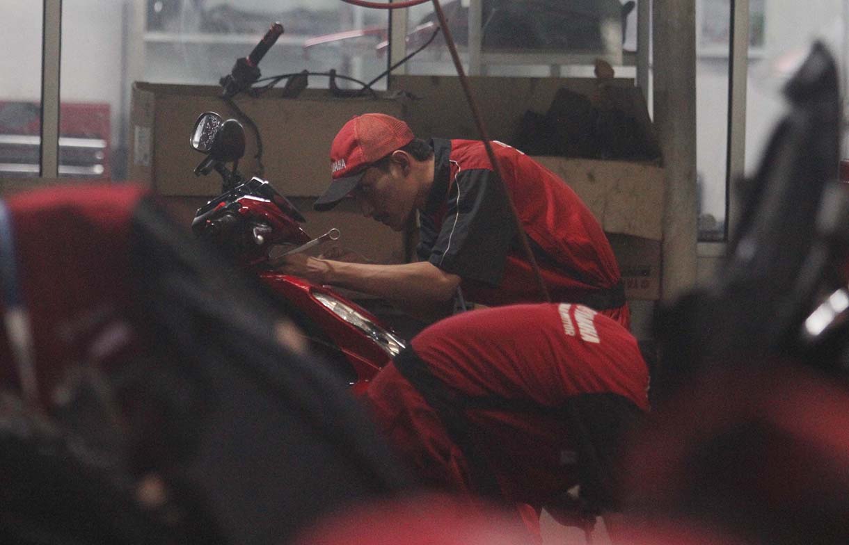 Mekanik memperbaiki motor di bengkel motor Yamaha, Bintaro, Jakarta, Rabu (19/3/2025).  (Beritanasional.com/Oke Atmaja)